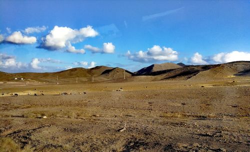 Scenic view of arid landscape against sky