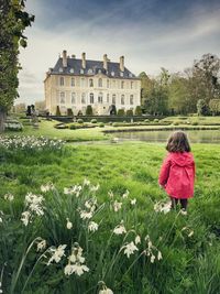 Rear view of person on field against sky