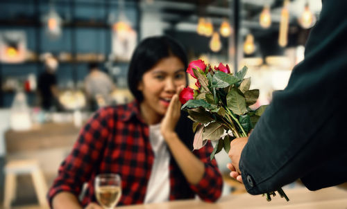 Young man holding rose bouquet