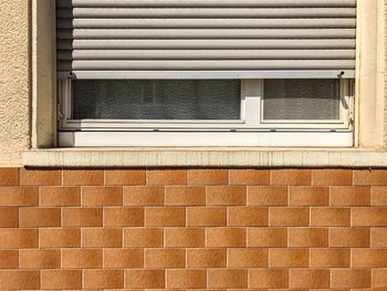 Full frame shot of window with blinds on wall