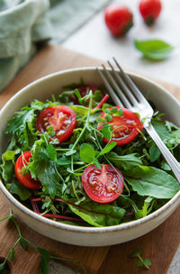 Vegan food healthy fresh vegetables salad. salad with arugula and cherry tomatoes.