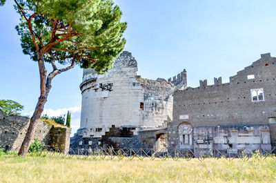 Low angle view of castle on field against sky