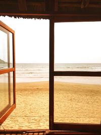 Scenic view of sea against clear sky seen through window