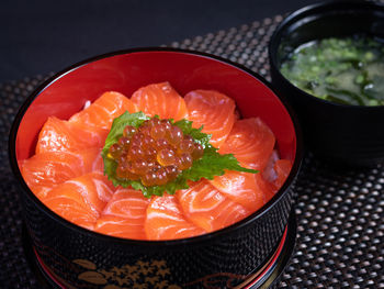 Salmon sashimi and salmon roe with rice bowl or donburi in japanese style food.