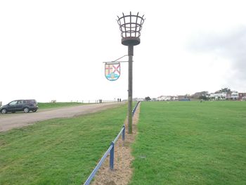 Street light on field against clear sky