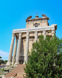 Low angle view of historical building against blue sky