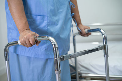 Midsection of handicapped person using mobility walker