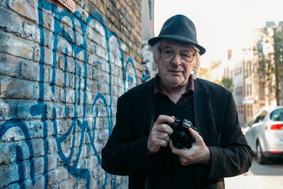 Portrait of man holding camera