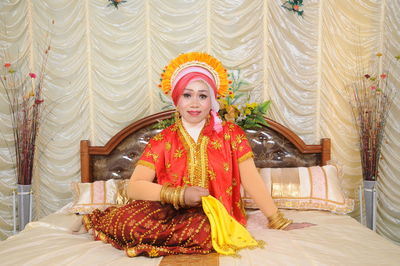 Portrait of young woman sitting at home