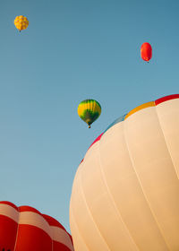 Low angle view of hot air balloons against blue sky