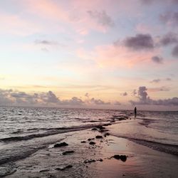 Scenic view of beach against sky during sunset