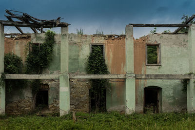 Abandoned built structure on field against sky