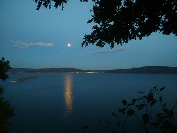 Scenic view of lake against sky at night