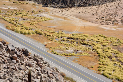 High angle view of road passing through a field