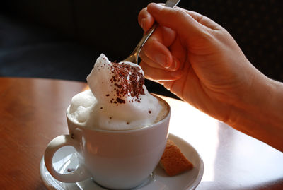 Close-up of hand holding ice cream