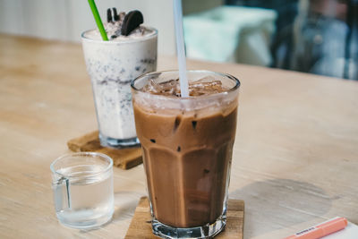 Iced latte coffee in a tall glass. cold summer drink background