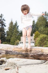 Girl standing on tree