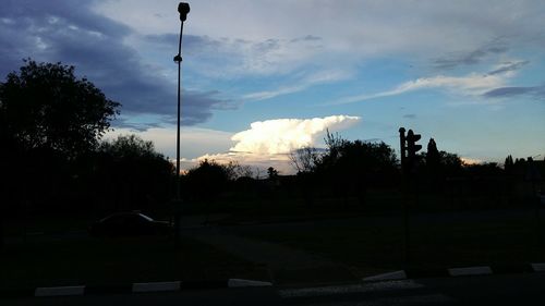 View of road against cloudy sky at sunset