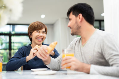 Portrait of a smiling young man holding food