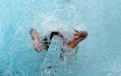 High angle view of boy swimming in pool