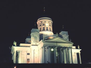 Low angle view of illuminated building against sky at night