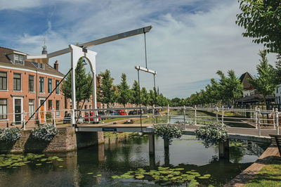 Canal with brick houses and bascule bridge in weesp. a pleasant small village in netherlands.