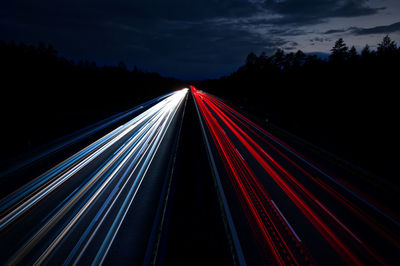 High angle view of light trails on highway at night