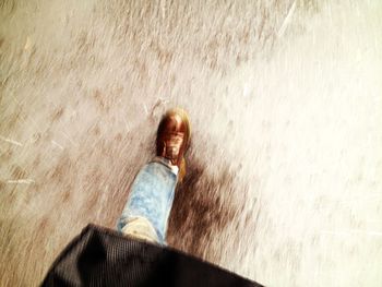 Young woman standing on tiled floor