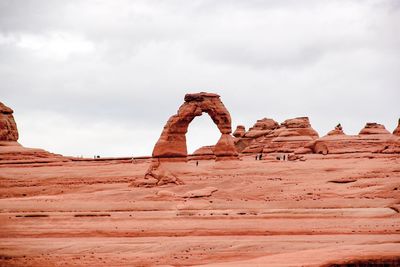 Rock formation on landscape against sky