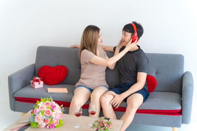 Woman sitting on sofa at home