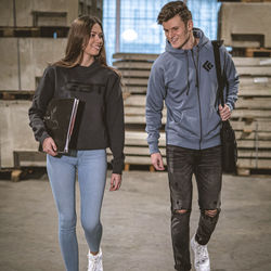 Full length portrait of a young couple standing outdoors