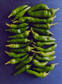 High angle view of green chili peppers on table