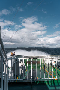 View of boats in sea against cloudy sky