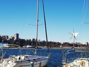 Sailboats sailing in sea against clear blue sky