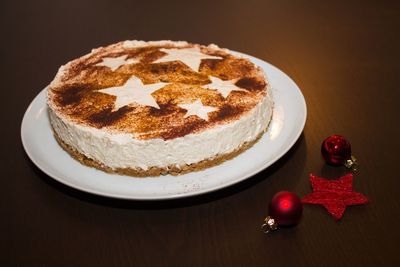 High angle view of christmas cake and decorations on table