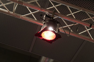 Low angle view of illuminated lamp hanging on ceiling