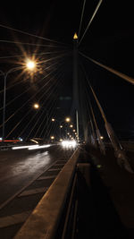 Illuminated road in city at night