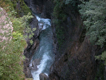 Scenic view of river flowing through rocks