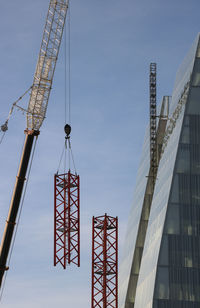 Low angle view of crane against clear sky