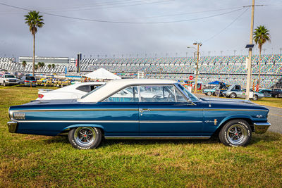 Vintage car in city against sky