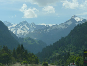 Scenic view of mountains against cloudy sky