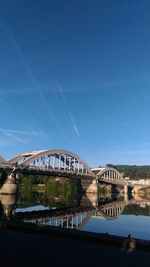 Bridge over river against buildings