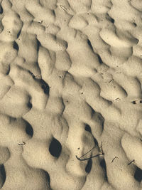 High angle view of footprints on sand