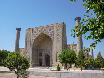 Low angle view of historical building against clear blue sky