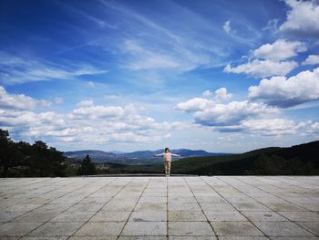 Full length of boy standing against sky