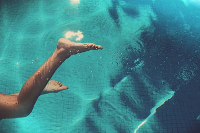 Low section of woman swimming in pool