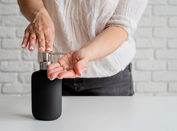 Close-up of man holding hands on table