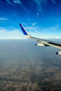 Cropped image of airplane flying over landscape