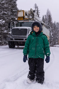 Portrait of young man skiing on snow