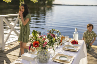 Children by set table by lake